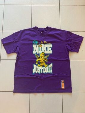 Nike Purple Graphic Tee with Yellow Cherub and Teal Accents
